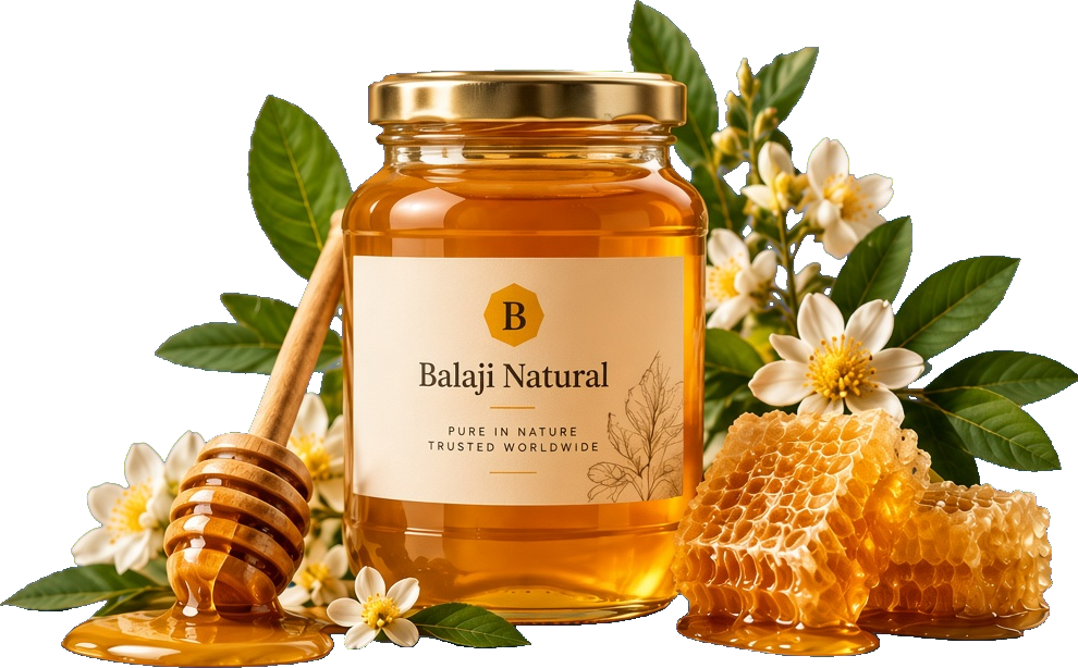 Jar of Balaji Natural honey with a wooden dipper, honeycomb, and white blossoms